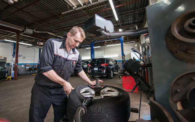 Technician balancing a tire at Auto Trust Centre